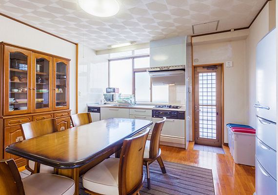 A kitchen with a large dining table