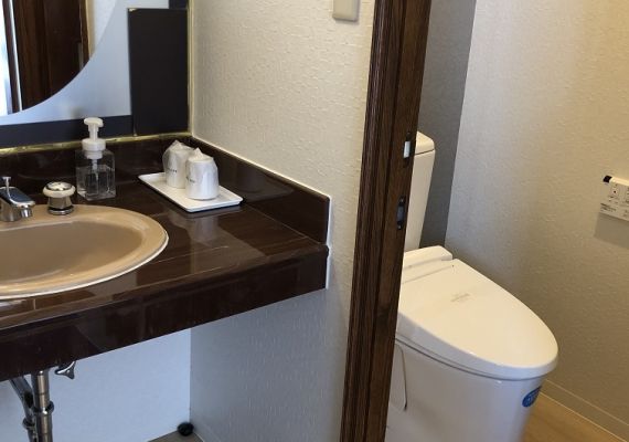 Toilet and washroom corner in the room.