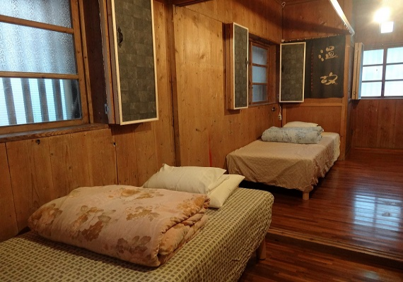 Wooden bedroom. We can add futons as extra bedding. 
