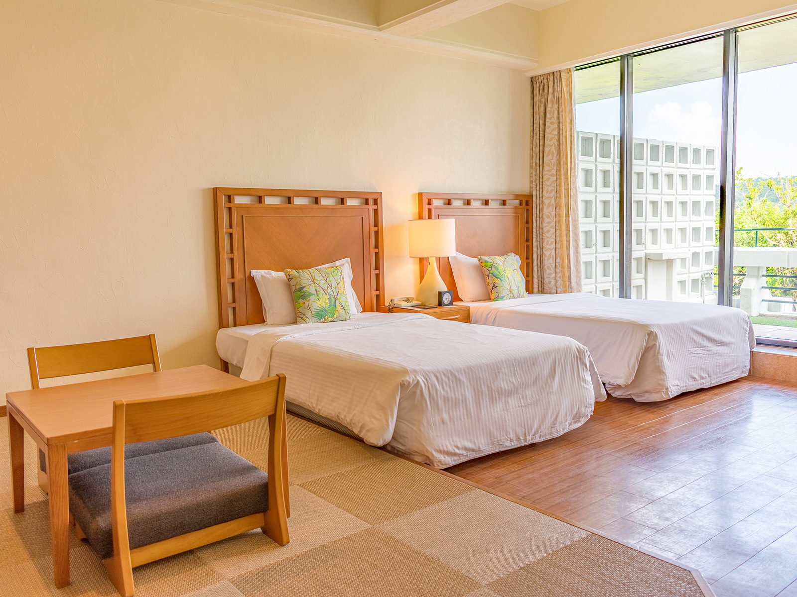 Natural Luxury is a room with 2 beds and a small raised tatami-floored seating area
